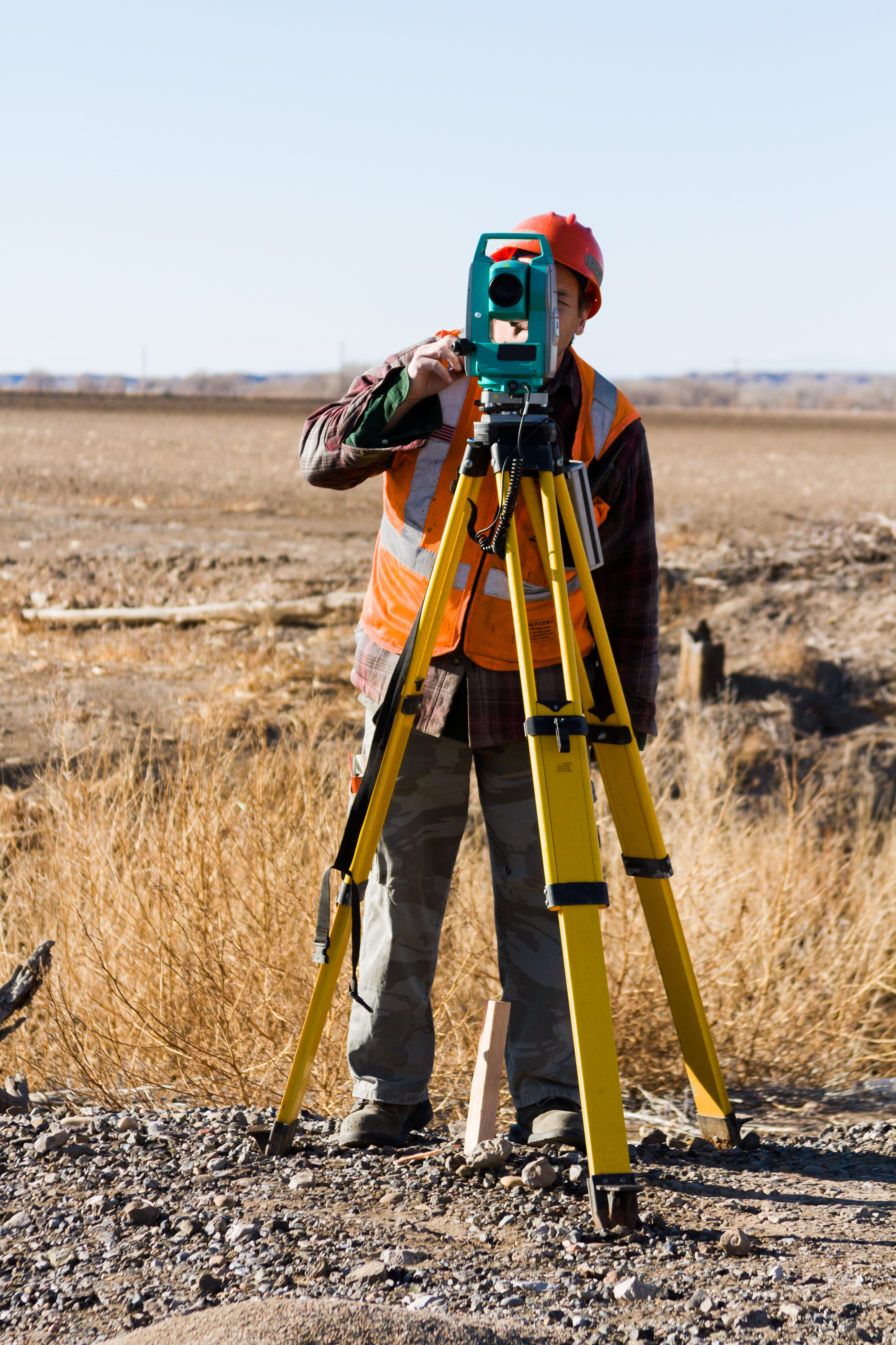 land surveyors measuring existing railroad bridge rural area
